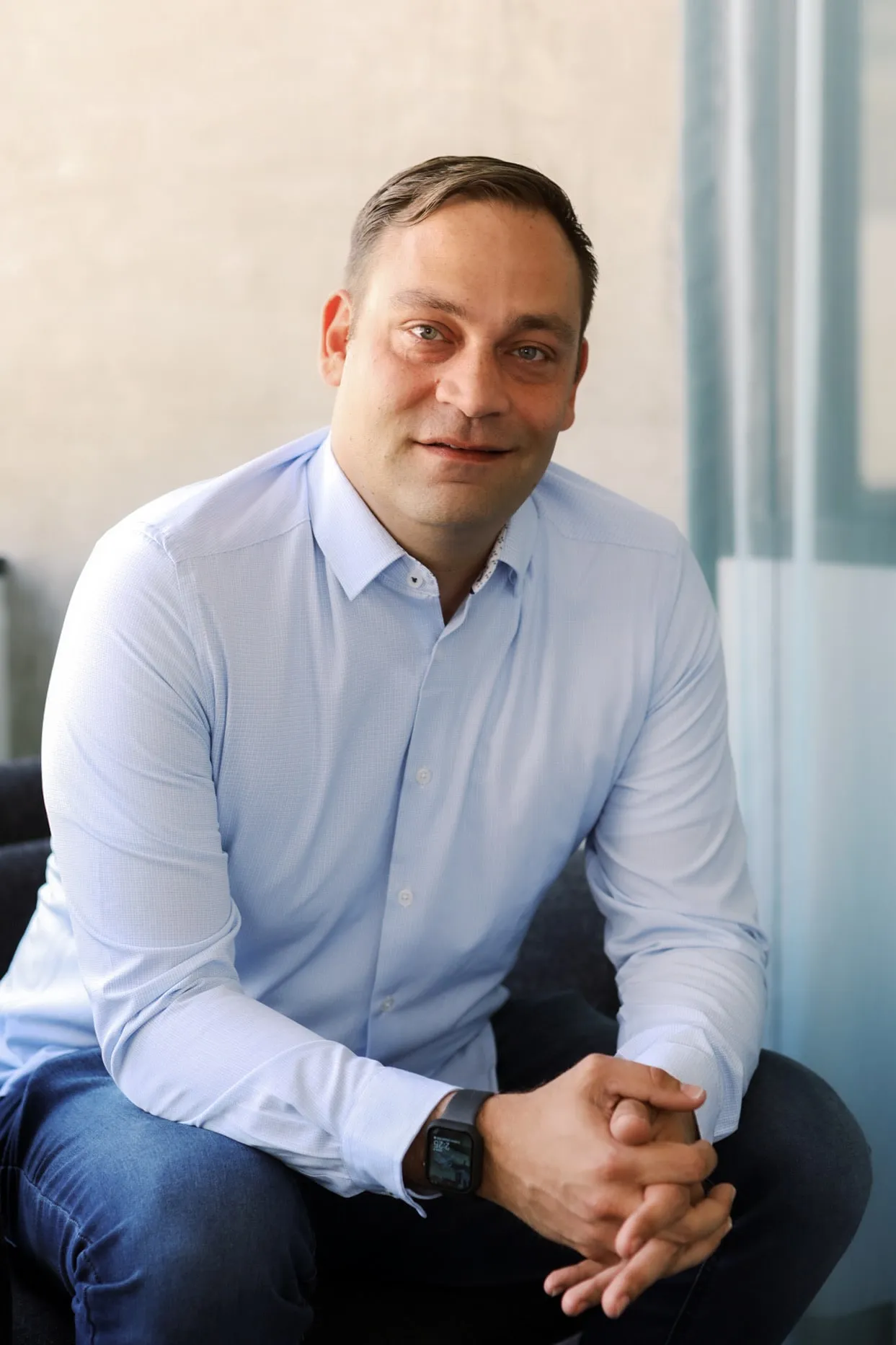 Eric Stoner, seated in a light blue shirt