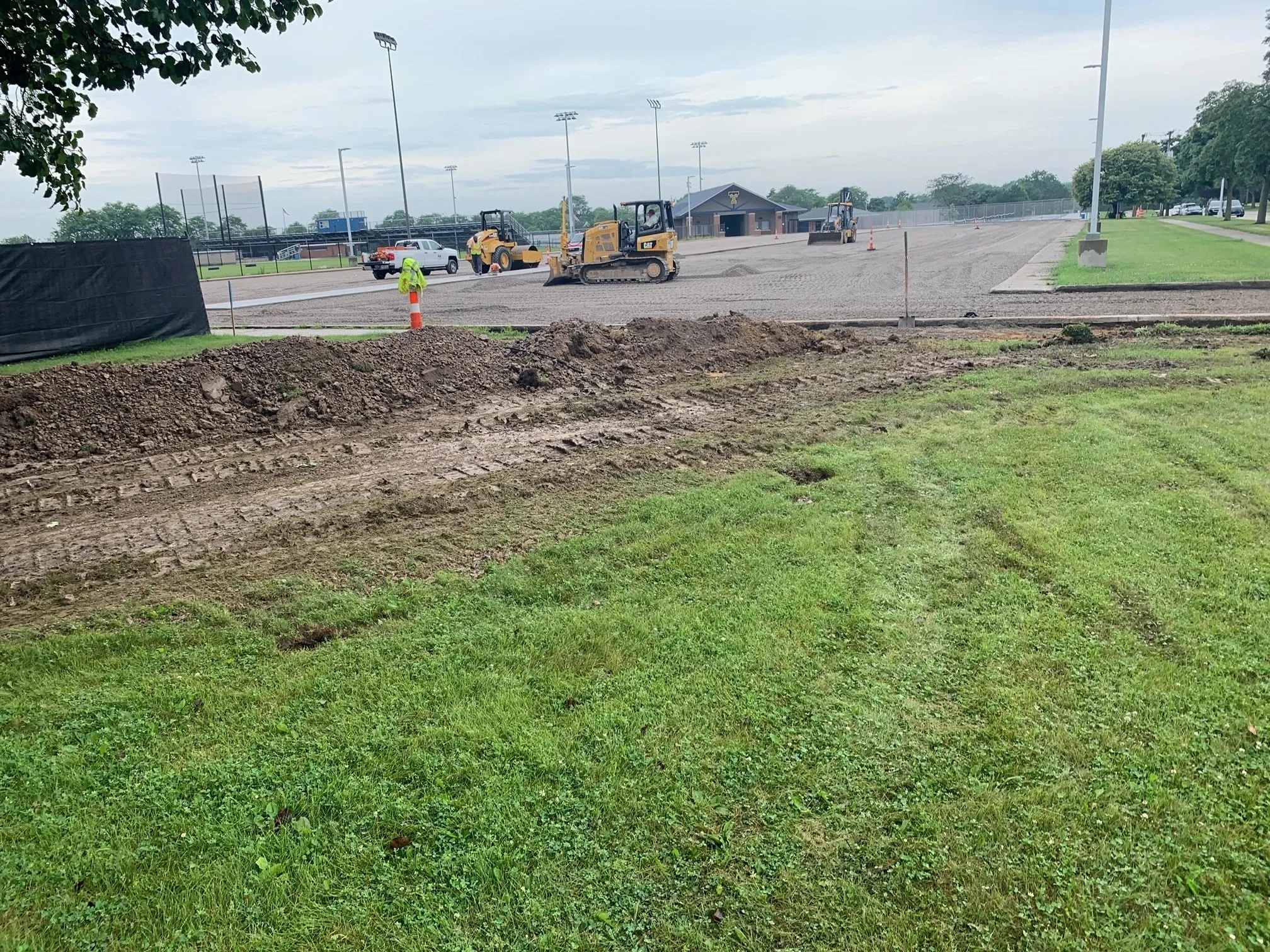 Earthmoving equipment grading the athletic field