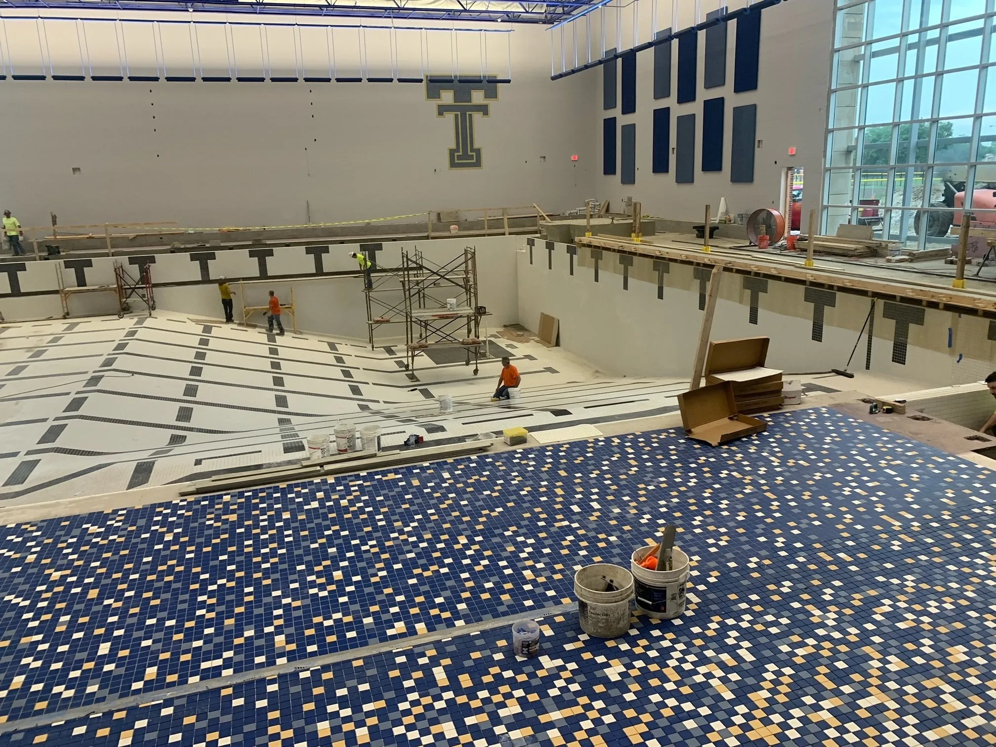 Tile crews building the natatorium